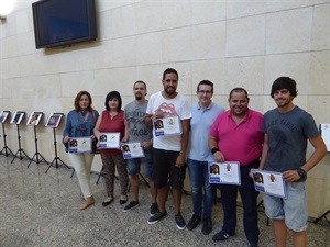 Los tres premiados junto a otros participantes del certamen fotográfico