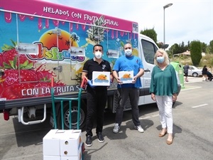 Un trabajador de la empresa Helados Disfrutis entregando la donación esta mañana junto a Beatriz Pérez Hickman, concejala de Bienestar Social y Bernabé Cano, alcalde de La Nucía