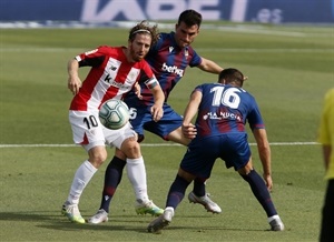 Iker Muniain driblando a  los jugadores del LEvante